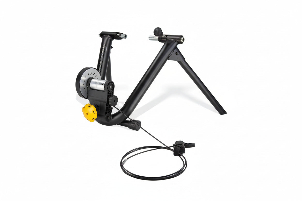 A black Saris Mag bicycle trainer with a yellow accent, featuring a magnetic resistance unit and a wire for connection.